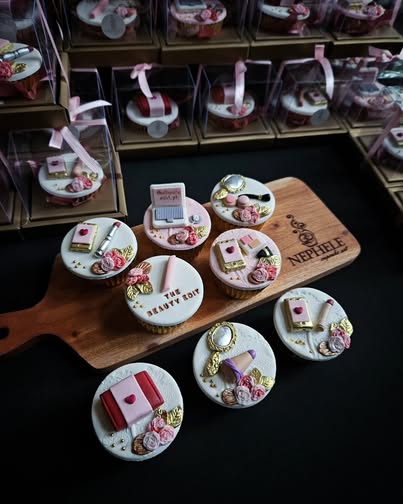 Nephele Cupcake Art cupcake bouquets — beauty-themed cupcakes on a wooden board
